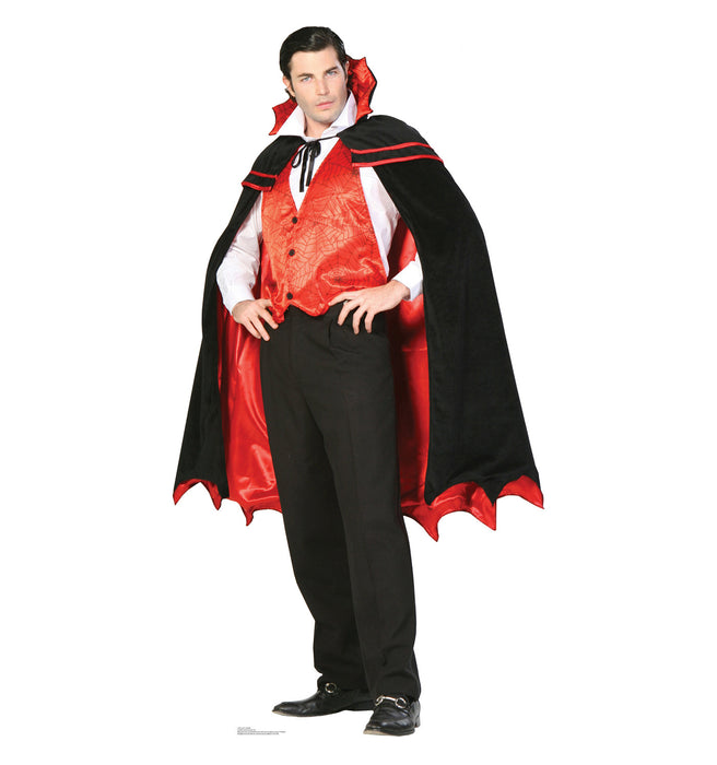 Cardboard cutout of a man dressed as a vampire in a red and black costume, featuring a red brocade vest, white shirt, black pants, and a dramatic black cape with red lining and high collar.