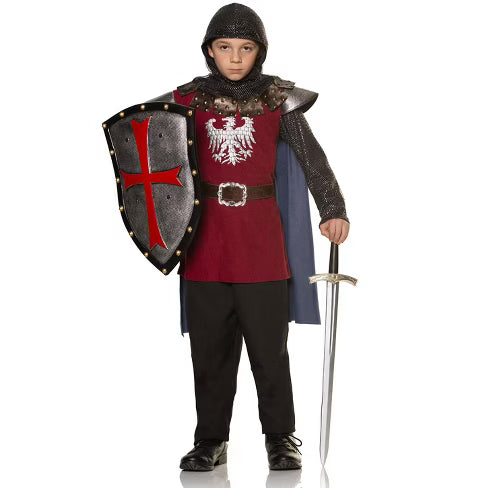 A child wearing a medieval-style King’s Guard costume featuring a red and black tunic with a gold crest emblem, a matching cape, and black pants—designed to evoke a noble royal protector
