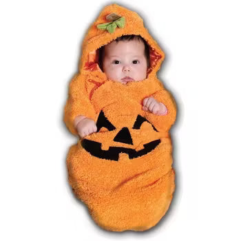 A smiling baby snugly dressed in an orange bunting costume designed to look like a pumpkin, complete with a jack-o'-lantern face on the front and a green leafy stem hood.