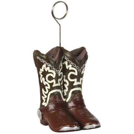 Cowboy boot-shaped balloon weight featuring a pair of brown and black boots with white decorative stitching, silver spurs, and a metal loop on top for securing balloons. Ideal for Western or cowboy-themed parties.
