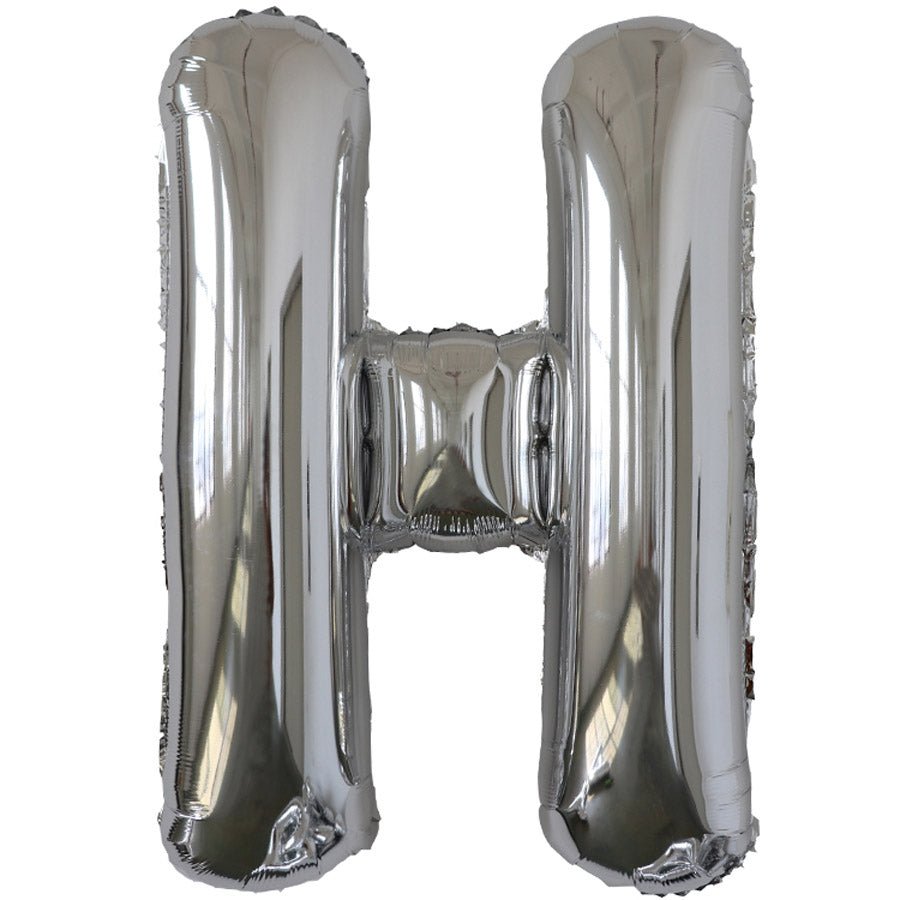 Silver foil balloon shaped like the letter H.