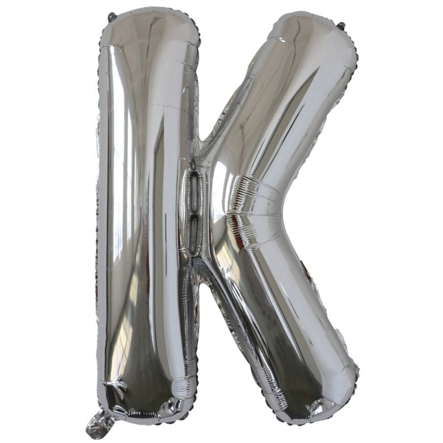 Silver foil balloon shaped like the letter K.