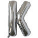 Silver foil balloon shaped like the letter K.