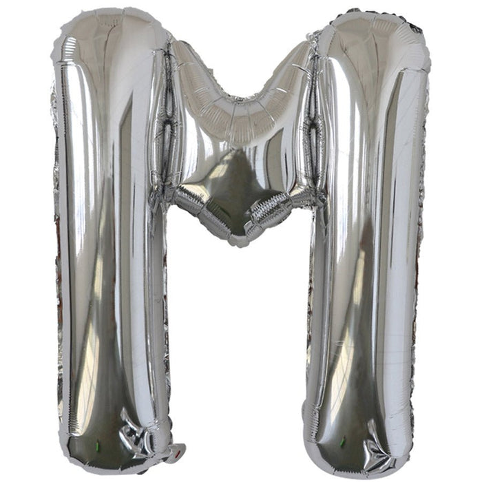 Silver foil balloon shaped like the letter M.
