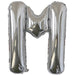 Silver foil balloon shaped like the letter M.
