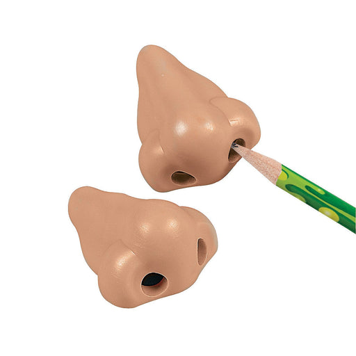 Novelty pencil sharpeners shaped like realistic human noses in a beige skin tone. Pencils are inserted into one nostril for sharpening, adding a humorous and playful touch to school or office supplies.