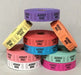 Stacked rolls of 'Admit One' tickets in assorted colors including purple, yellow, orange, red, blue, teal, white, and pink, arranged in a pyramid shape against a gray background.