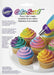 Package of Wilton Color Swirl Three-Color Coupler with an image showing cupcakes decorated in swirled multicolored frosting.