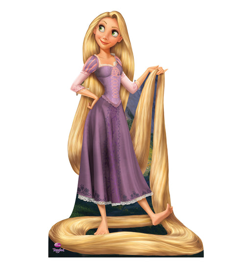 Life-size cardboard cutout of a cartoon princess with long golden hair wearing a purple dress, standing barefoot with her hair wrapped around her feet and held in one hand, smiling and gazing off to the side.
