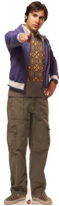 Life-size cardboard cutout of a man pointing forward with a confident expression, wearing a purple jacket over a patterned sweater, olive green cargo pants, and checkered slip-on shoes.