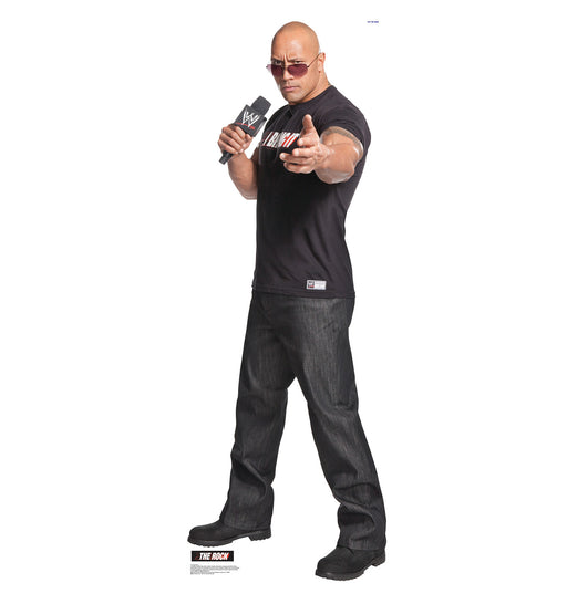 Life-size cardboard cutout of a muscular man wearing sunglasses, a black t-shirt, and dark jeans, holding a WWE microphone and pointing directly forward with a confident expression.