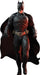 Life-size cardboard cutout of a muscular superhero dressed in a detailed black armored Batsuit with a gold utility belt, black gloves, boots, and a flowing black cape. He wears a cowl with pointed ears and strides forward with a serious expression.