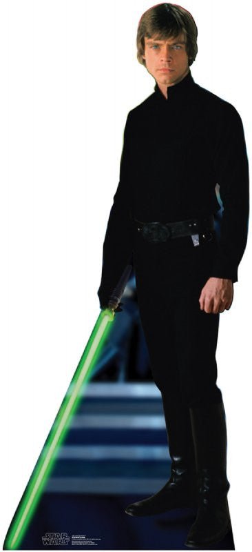 Life-size cardboard cutout of a young man dressed in an all-black outfit with a black belt and boots, holding a glowing green lightsaber in his right hand. He stands confidently with a serious expression in front of a futuristic staircase. The Star Wars logo is at the bottom corner.