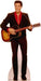 Life-size cardboard cutout of a smiling man with slicked-back hair wearing a black suit with a red shirt, holding an acoustic guitar as if mid-performance.