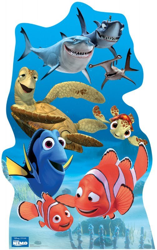 Life-size cardboard cutout featuring animated underwater characters from Disney·Pixar's Finding Nemo. In the foreground are Nemo and Marlin, two orange clownfish, and Dory, a blue tang. Behind them are Crush and Squirt, two sea turtles, along with three friendly sharks and two hammerhead sharks swimming in the background. The ocean scene is filled with vibrant blue tones and coral silhouettes. The Finding Nemo logo appears in the corner.