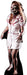Life-size cardboard cutout of a zombie nurse with long disheveled blonde hair, wearing a short white dress with red trim, splattered with blood. Her face is painted with skeletal makeup and wounds, and she has an aggressive posture with one claw-like hand reaching forward. Her legs are covered in fishnet stockings, one torn, and she is barefoot.