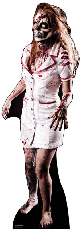 Life-size cardboard cutout of a zombie nurse with long disheveled blonde hair, wearing a short white dress with red trim, splattered with blood. Her face is painted with skeletal makeup and wounds, and she has an aggressive posture with one claw-like hand reaching forward. Her legs are covered in fishnet stockings, one torn, and she is barefoot.