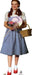 Young girl with fair skin and auburn pigtails, wearing a white puff-sleeved blouse and a light blue gingham pinafore dress. She holds a pastel pink and purple swirled lollipop and a small bouquet of pink and purple flowers. A light brown wicker basket hangs from her left arm. She wears white socks and sparkling ruby red shoes.