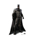 Cut-out of Batman, the comic book superhero, standing in a strong stance with fists clenched. He is wearing a dark gray armored suit with the bat emblem on his chest, a black cape draped over his shoulders, black gloves, boots, and cowl with pointed ears.