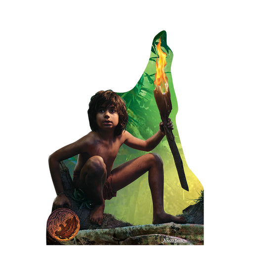 Cardboard cutout of Mowgli from The Jungle Book movie, crouching with a lit torch in his right hand, set against a green and yellow jungle background, with a round brown Jungle Book logo near the bottom left.