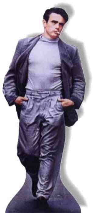 Cardboard cutout of a man confidently walking forward with hands in his pockets. He has short dark hair and a serious expression. He is dressed in a muted gray turtleneck shirt, high-waisted pleated pants, and a loose-fitting blazer in a matching cool-toned shade. The outfit has a soft satin-like sheen, giving it a vintage, stylized look.