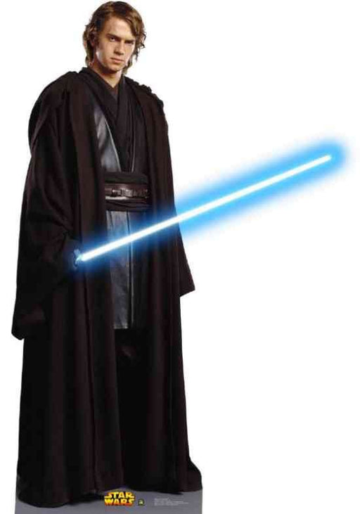 Life-size cardboard cutout of Anakin Skywalker from Star Wars, wearing a dark brown Jedi robe over a black tunic and belt. He holds a glowing blue lightsaber angled across his body. The cutout stands on a base with the yellow and red Star Wars logo.