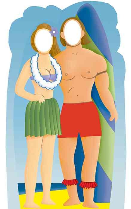 Colorful cartoon-style cardboard cutout of a Hawaiian couple standing on a beach. The woman wears a green grass skirt, purple top, white lei, and has a purple flower in her brown hair. The shirtless man wears red shorts and red ankle garlands, holding a large blue and green striped surfboard. Both have blank oval faces for photo opportunities.