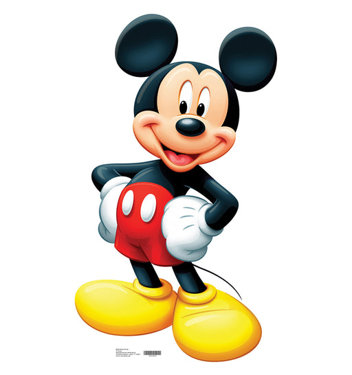 Cardboard cutout of Mickey Mouse standing with hands on hips, smiling confidently. He is wearing red shorts with white buttons, yellow shoes, and white gloves.