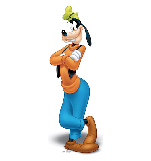 Cardboard cutout of Goofy standing with arms crossed and one foot raised, wearing a green hat, orange sweater, blue pants, brown shoes, and a cheerful expression.