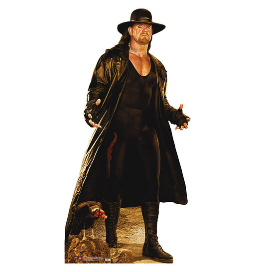 Life-size cardboard cutout of a man dressed in a dramatic black outfit featuring a long trench coat, wide-brimmed black hat, black gloves, and black boots, standing in a powerful pose with a stern expression.
