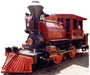A vintage steam locomotive painted in red and black with gold accents, marked with the number '1' on the front and labeled 'Pacific Coast Railroad Co.' on the side, featuring a tall smokestack, cowcatcher, and American flags.