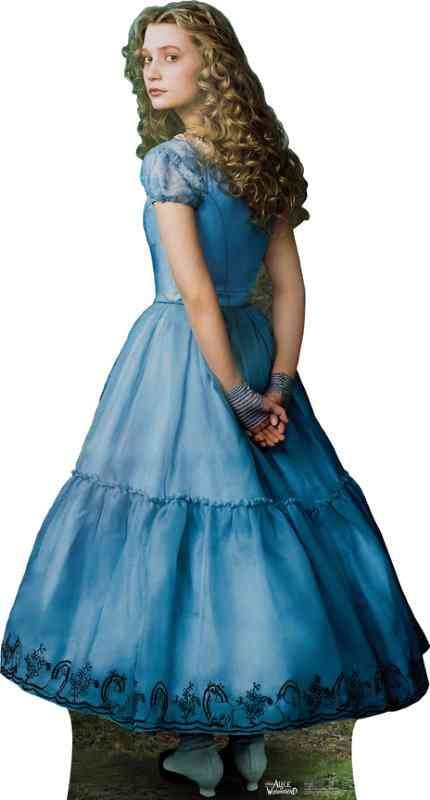 A young woman with long curly blonde hair wearing a light blue, floor-length dress with dark blue embroidery along the hem.