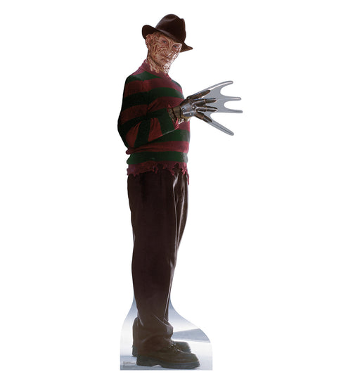 A life-size cutout of a burned-faced man wearing a brown fedora, red and green striped sweater, dark pants, black shoes, and a bladed glove on his right hand.