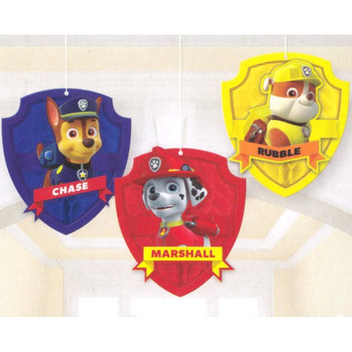 Set of three hanging Paw Patrol decorations shaped like colorful shields, each featuring a character: Chase on a blue shield, Marshall on a red shield, and Rubble on a yellow shield, with their names printed on banners below.