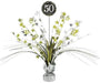 Table centerpiece decoration with metallic silver and gold foil sprays, star accents, and number cutouts, featuring a black circular topper with '50' in white glitter text.
