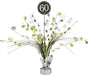 Table centerpiece decoration with metallic silver and gold foil sprays, star accents, and number cutouts, featuring a black circular topper with '60' in white glitter text.