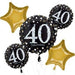 Arrangement of gold star-shaped balloons and black round balloons with white '40 happy birthday' text, decorated with white and gold dots.