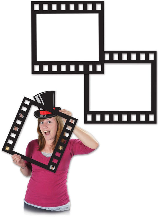 Black photo booth props shaped like square film strips, one held by a smiling woman wearing a red and black top hat, with two empty frames shown in the background.