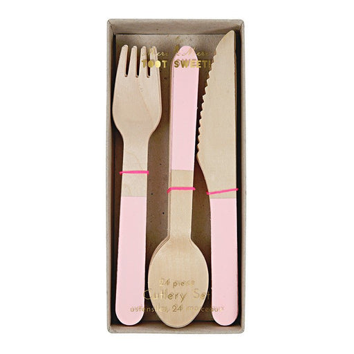 Box containing 24-piece wooden cutlery set with light pink painted handles, including a fork, spoon, and serrated knife, packaged in a rectangular cardboard box with a clear cover.