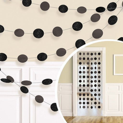 Black circle garland decoration with glitter and solid cutouts, shown strung across a wall and displayed as a hanging doorway curtain accent, ideal for parties or celebrations.