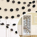 Black circle garland decoration with glitter and solid cutouts, shown strung across a wall and displayed as a hanging doorway curtain accent, ideal for parties or celebrations.