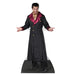 Cardboard cutout of a man wearing a long black coat with maroon satin lapels and cuffs, gold shirt, and black pants, posed with arms outstretched and a confident expression.