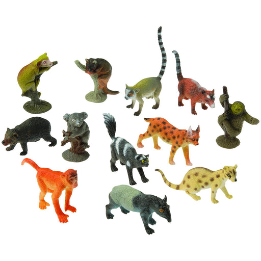 Assorted plastic toy figures of exotic and jungle animals in various colors and poses. The set includes animals such as lemurs, sloths, koalas, wildcats, and primates. Colors range from realistic gray, brown, and black to more vibrant tones like orange, yellow, and green. Several animals feature detailed striping or spots, such as a ring-tailed lemur with a striped tail, a yellow-spotted feline, and an orange-spotted wildcat. The figures stand on small bases or directly on their feet.
