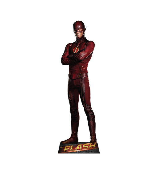 Life-size cardboard cutout of The Flash standing with arms crossed, wearing his red superhero suit with lightning bolt emblem on the chest and mask covering his face, positioned on a base labeled 'The Flash'.