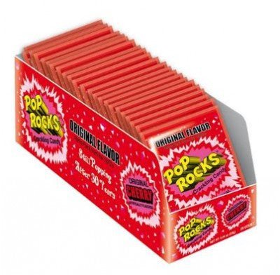 Box display of Pop Rocks popping candy, original cherry flavor, featuring multiple red packets with yellow logo text and explosive design graphics.