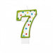 White number 7 birthday candle with a green outline and multicolored polka dots in red, blue, yellow, and green.