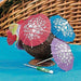 A set of colorful cocktail umbrella picks, designed to resemble small paper parasols. The umbrellas come in bright colors such as red, blue, purple, and are decorated with white floral patterns. Commonly used as decorative picks for drinks, fruit, or desserts at parties and tropical-themed events.