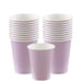 Stack of light purple paper cups with white rims, arranged in two tall stacks and one single cup in front.