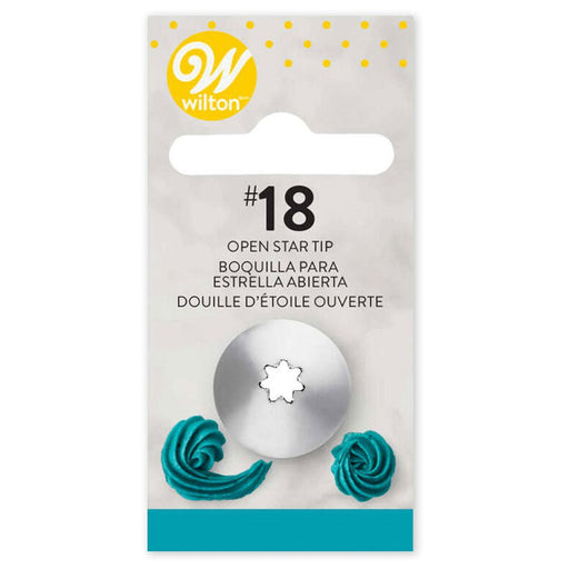 Wilton #18 open star piping tip in retail packaging. The metal tip with a small open star-shaped opening is mounted on a light gray card. The packaging features a yellow Wilton logo at the top and product name in English, Spanish, and French. At the bottom, two teal icing swirl examples show the tip’s piping effect.
