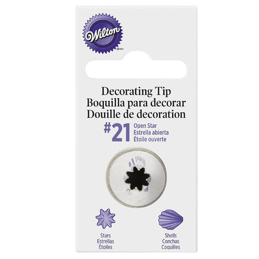 Wilton #21 open star decorating tip in retail packaging. The packaging features a white background with purple accents, including a purple Wilton logo at the top and a purple product number and text. The metal tip is attached in the center, and the bottom shows purple and lavender illustrations of piped star and shell icing designs.